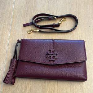 Never used. Tory Birch pebbled leather crossbody with tassels in maroon.
